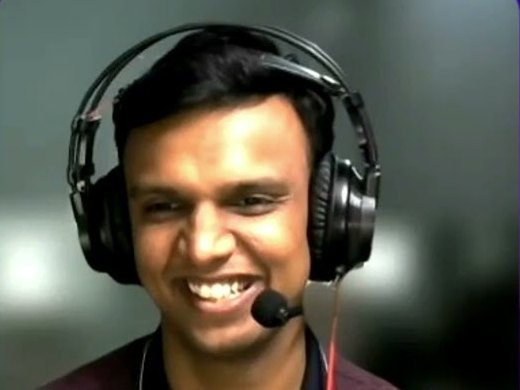 Gaurav, headphones on, laughing during the recording